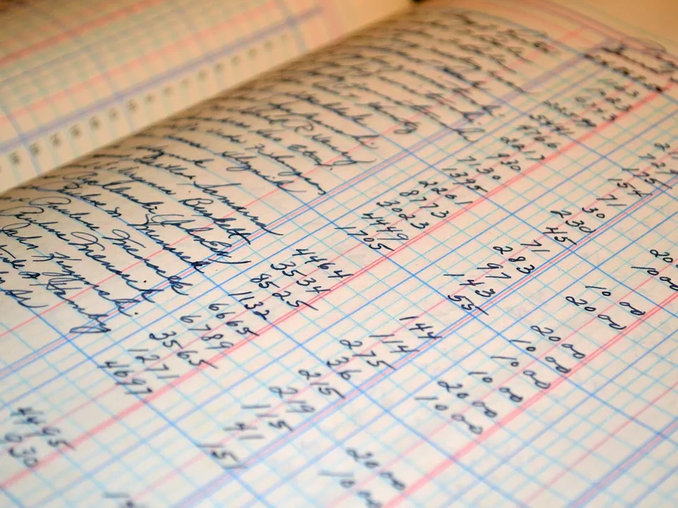 A handwritten accounting ledger, its ruled columns filled with figures in ink.